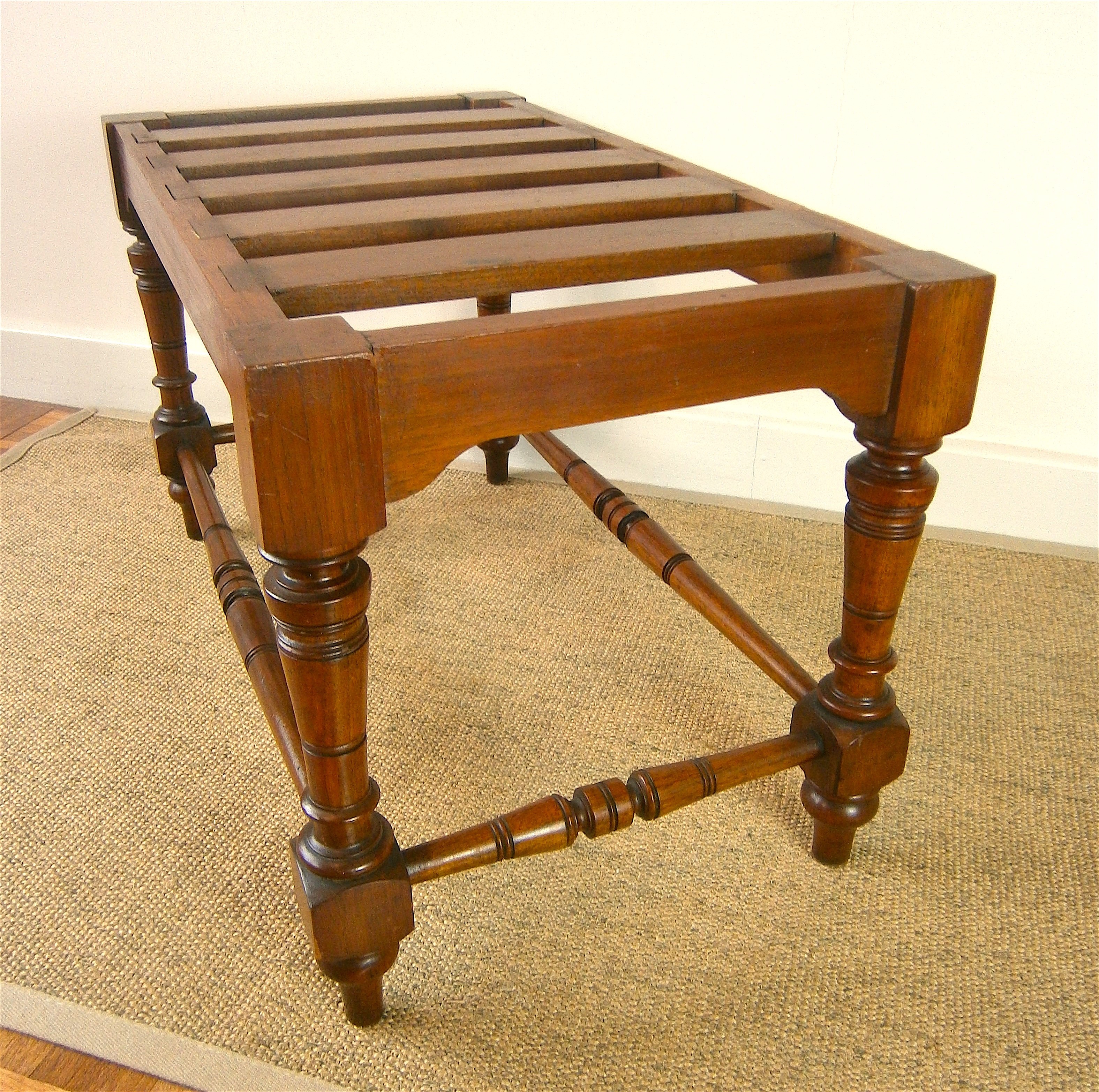 A late Victorian aesthetic movement walnut luggage stand, length 69cm, depth 38cm, height 41cm